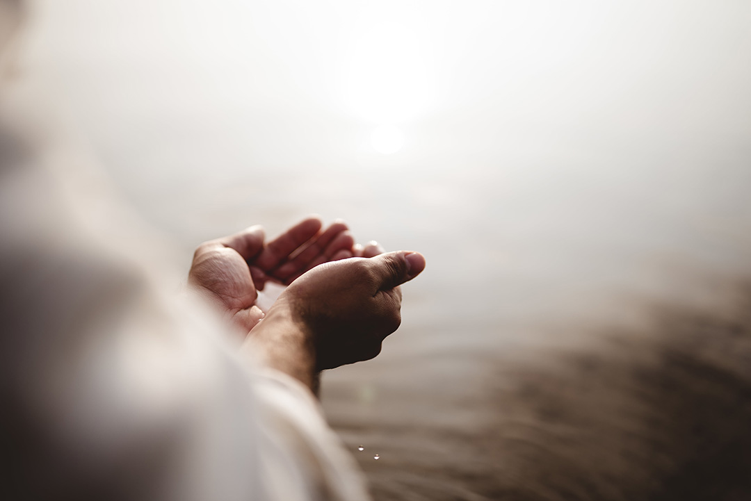 hands-holding-baptismal-water