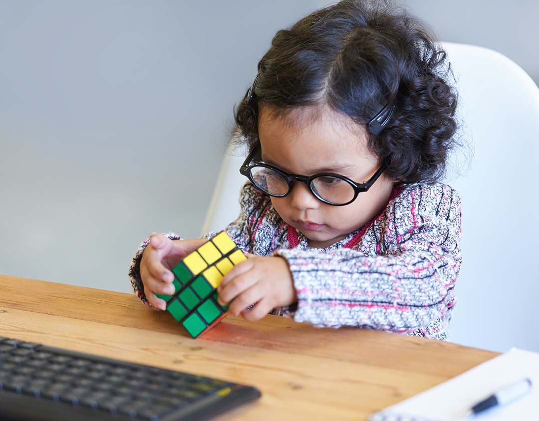 child playing with a Rubik's cube