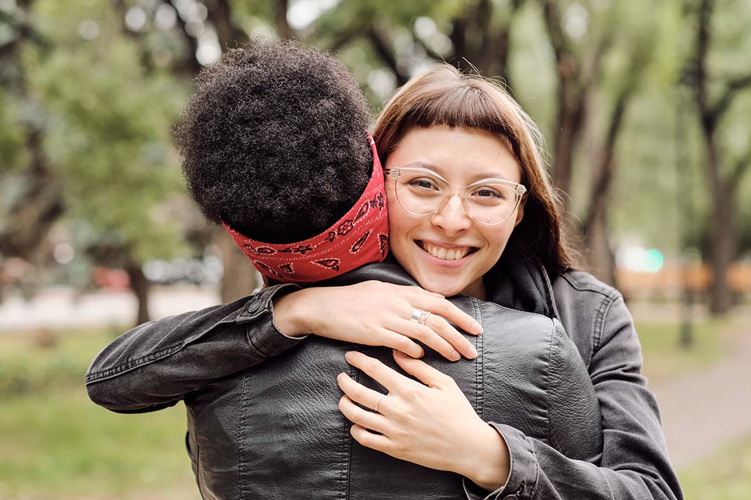 female friends embracing in a warm greeting