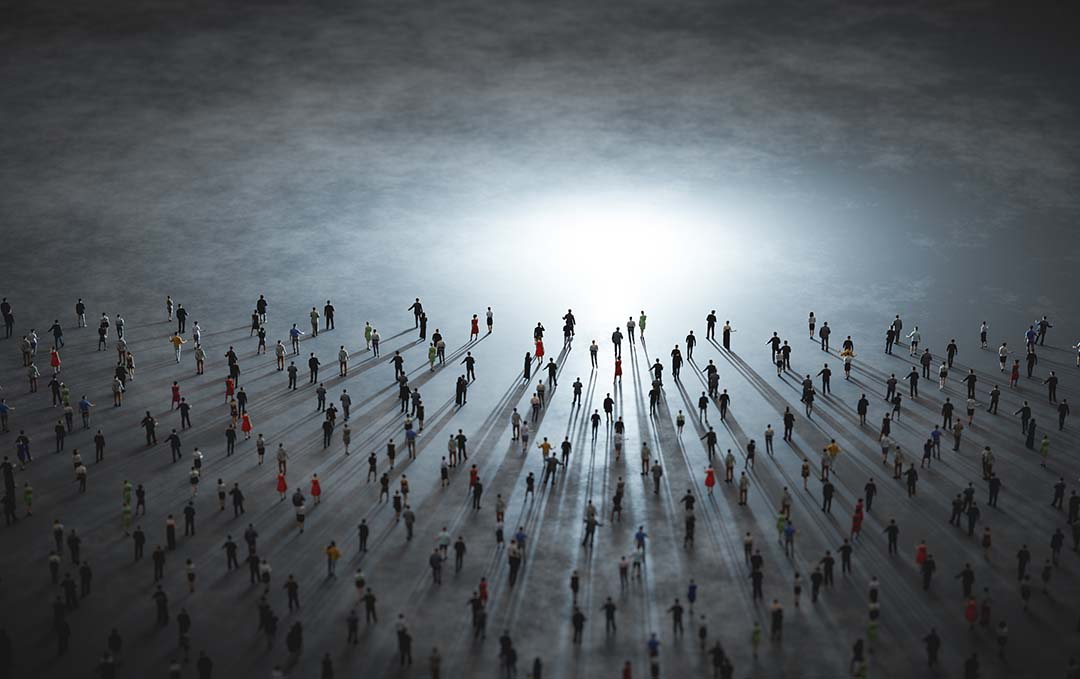 people walking towards a light