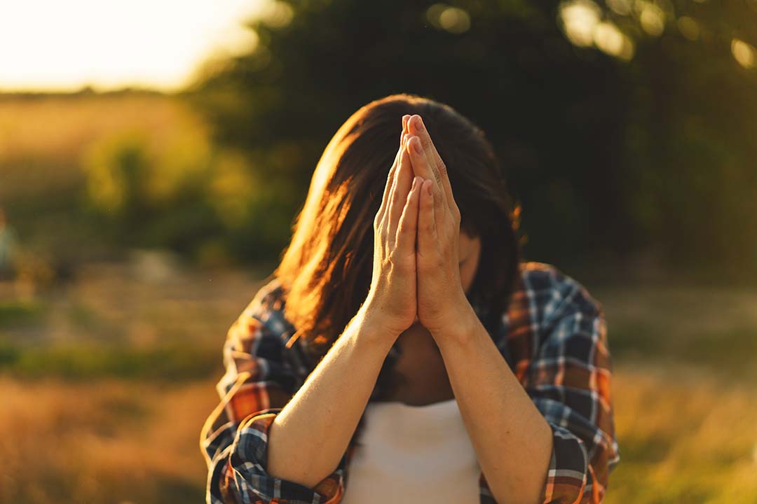 woman praying outdoors