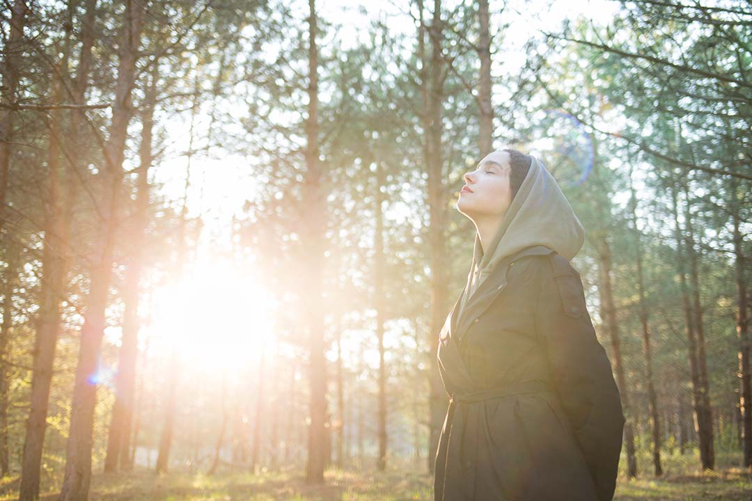 woman standing in a forest