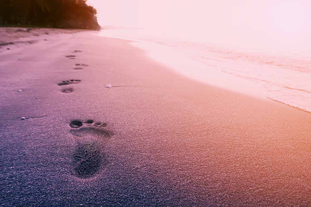 following footsteps on the beach