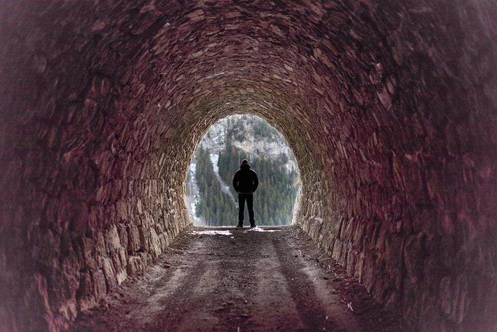 unregonisable figure standing at the end of a tunnel